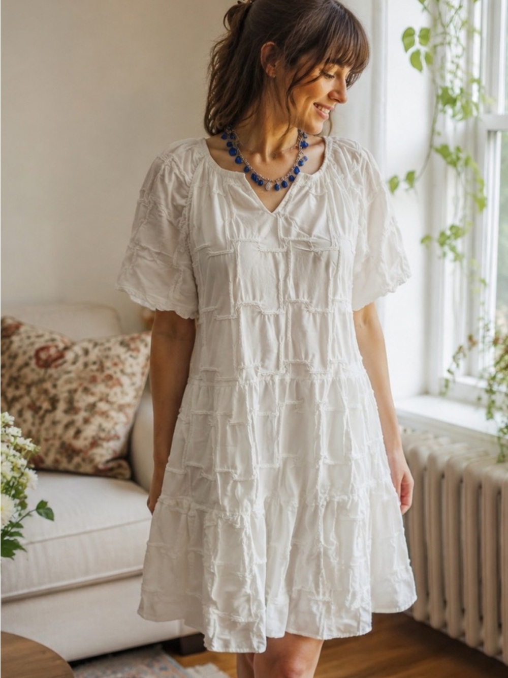 white textured babydoll dress from Cloth & Portrait with unique grid pattern